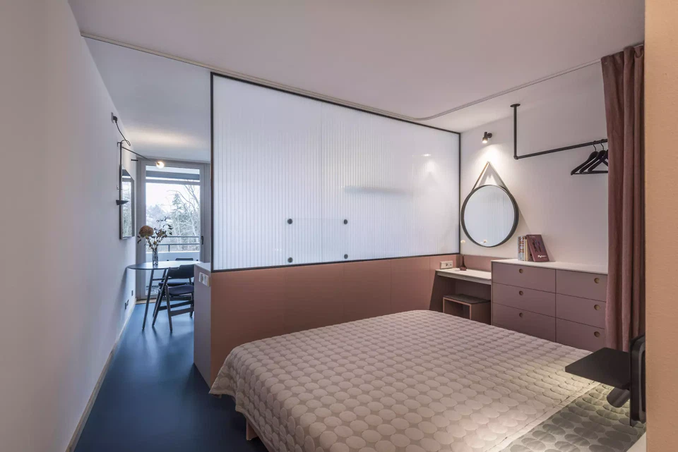 Offener Schlafzimmerbereich mit Abstellraum, Kleiderschrank und Arbeitsnische.