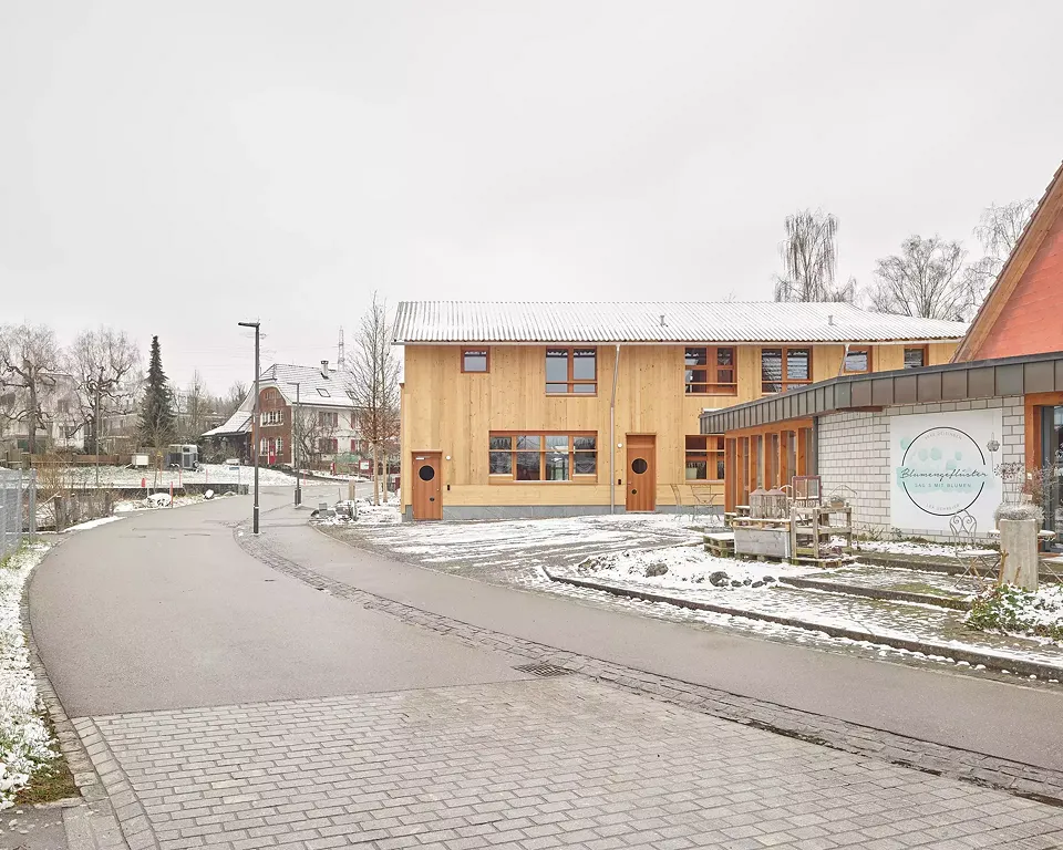 Der Neubau schiebt sich in der zweiten Reihe nahe an die Schulhausstrasse und formuliert einen kleinen Vorplatz.