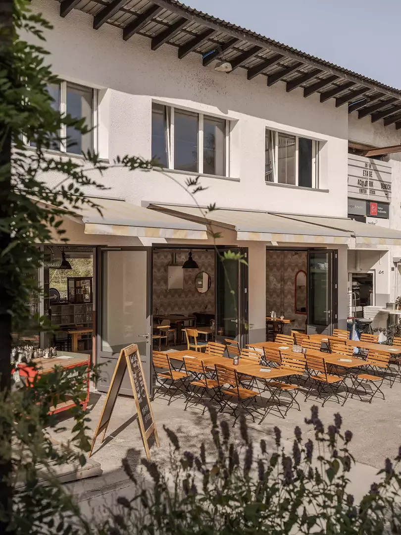 Eine einladende grüne Aussenterrasse erweitert die Bar.