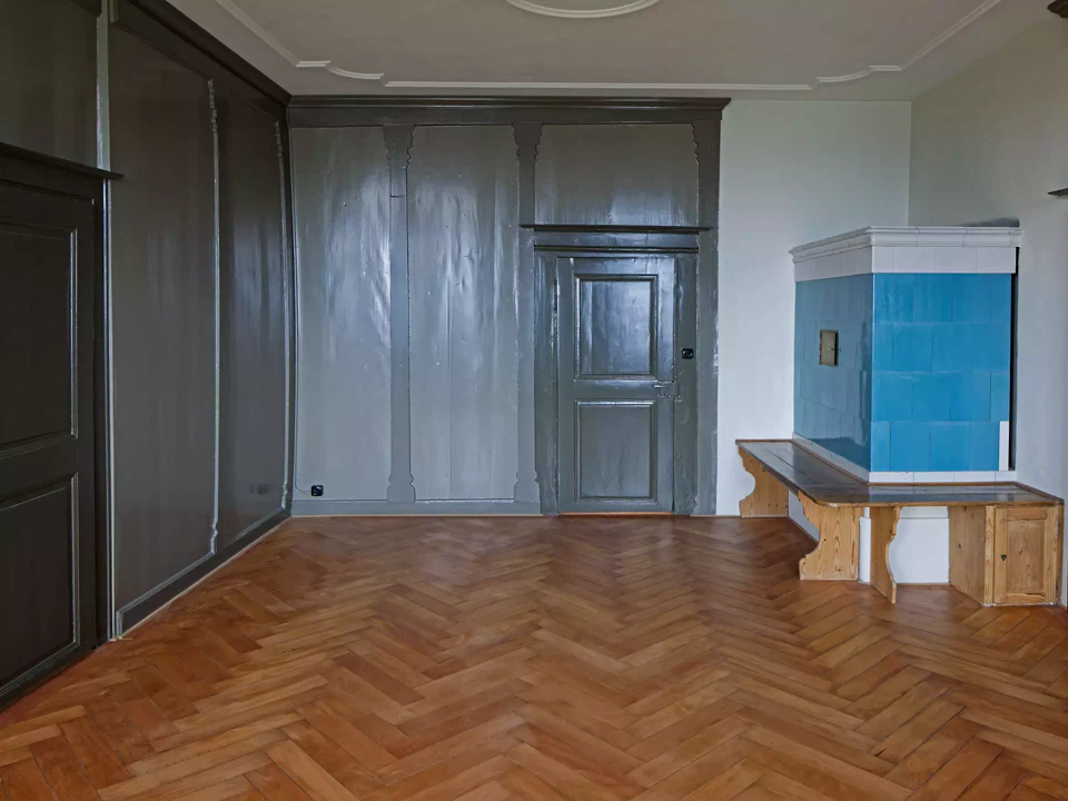 Mittleres Südostzimmer Erdgeschoss, grüner Täfer mit Kachelofen